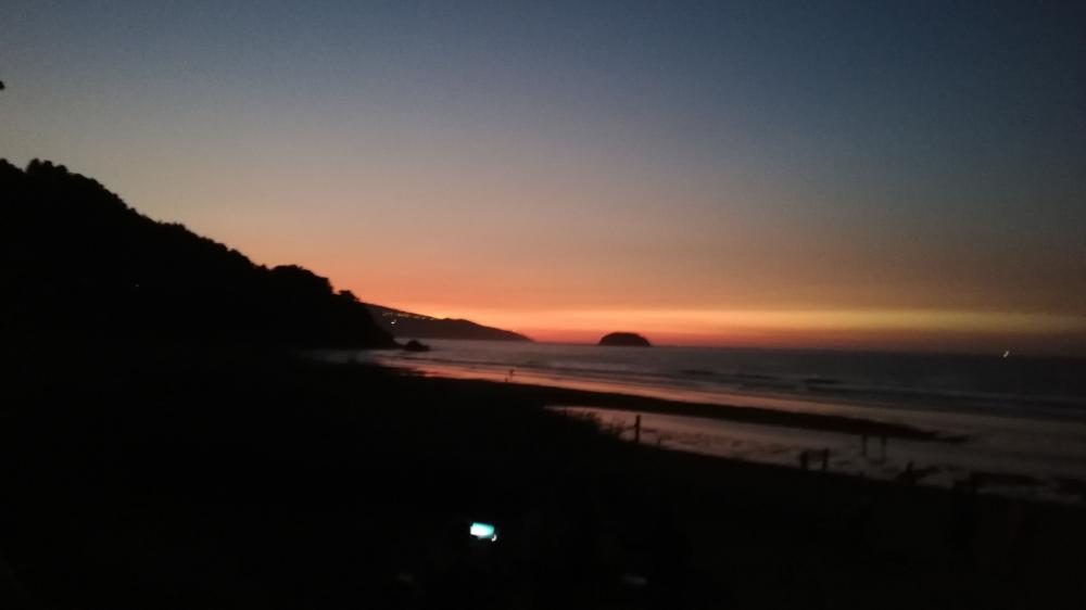 Serene Sunset Over Tranquil Beach Scene wallpaper