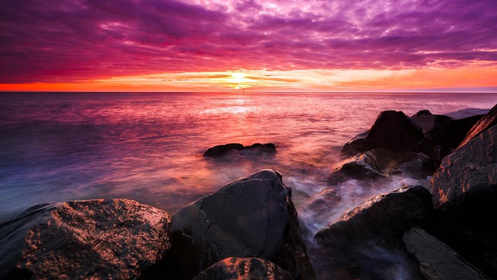 Sunset Over Misty Ocean Rocks wallpaper