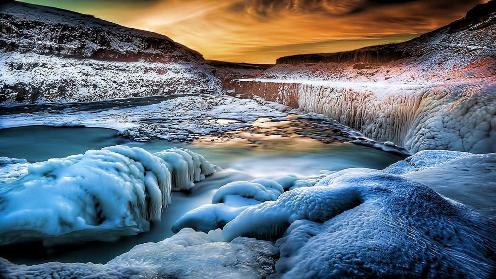 Winter's Icy Embrace by the Riverbank wallpaper