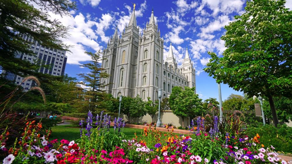 Majestic Cityscape with Lush Gardens and Historic Architecture wallpaper