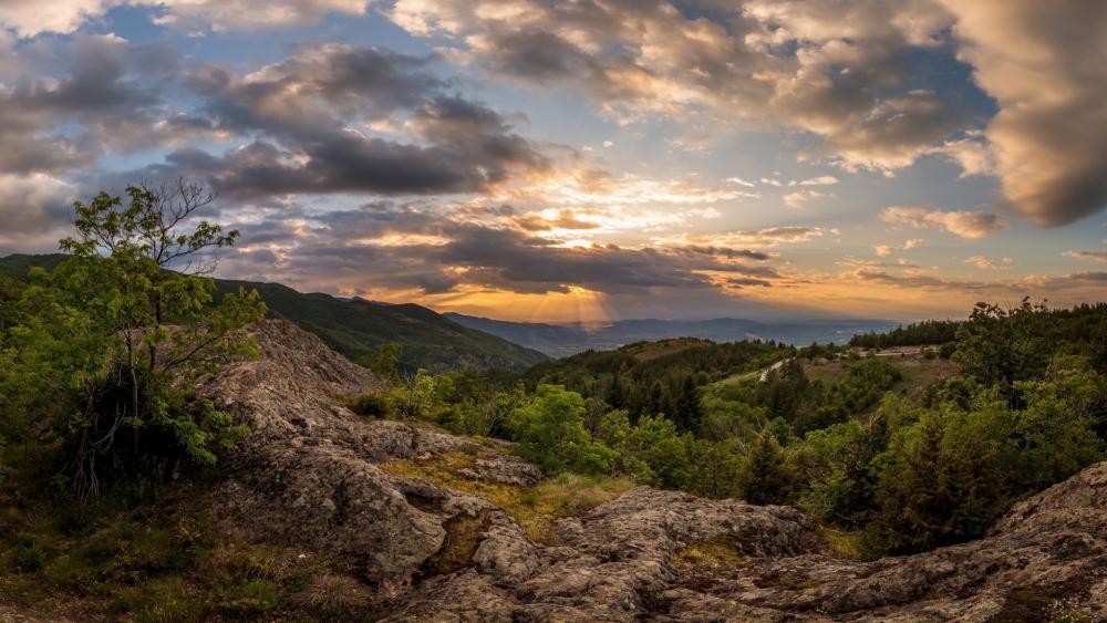 Majestic Mountain Sunset Overlooking Lush Landscape wallpaper