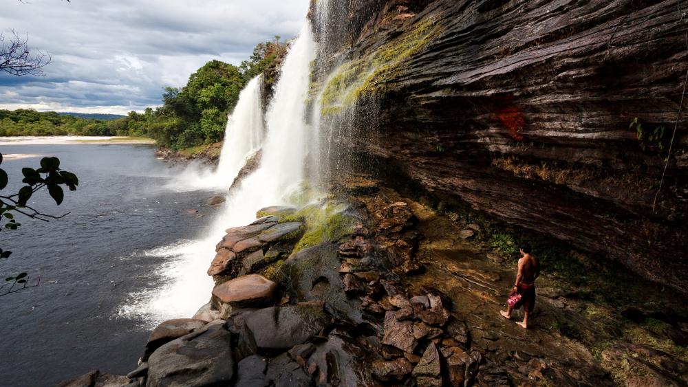 Man walking towards waterfalls, Canaima National Park wallpaper