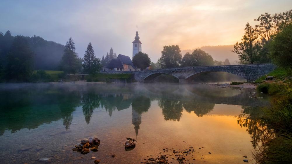 The Church of St. John the Baptist on the banks of the Sava River near Lake Bohinj in Slovenia wallpaper
