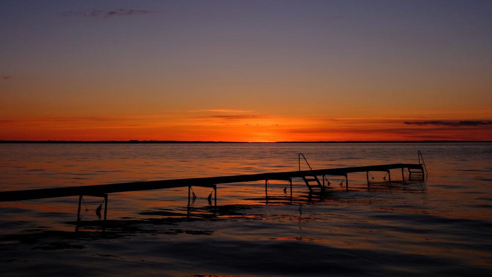 Pier on beach at sunset wallpaper