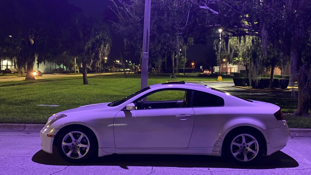 Sleek White Coupe on a Night Drive wallpaper
