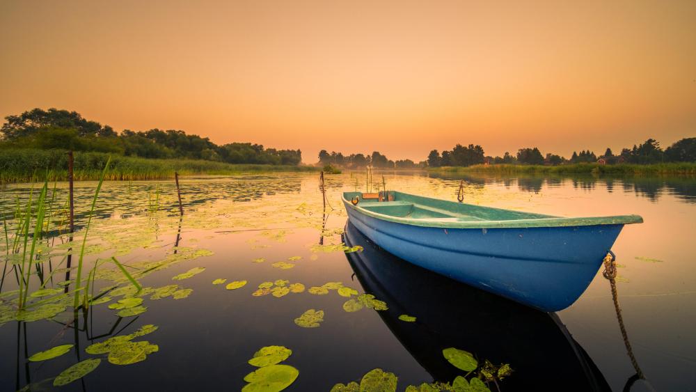 Serene Lake Sunrise with Blue Boat wallpaper