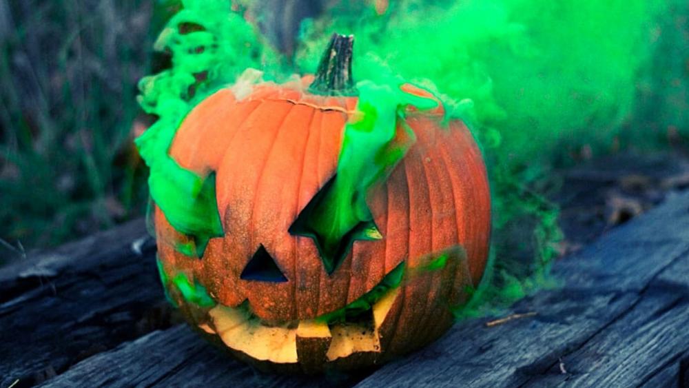 Mystic Halloween Pumpkin Amid Green Fog wallpaper