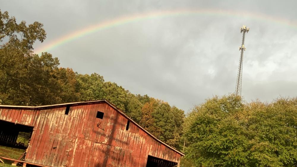 Rainbow over barn wallpaper