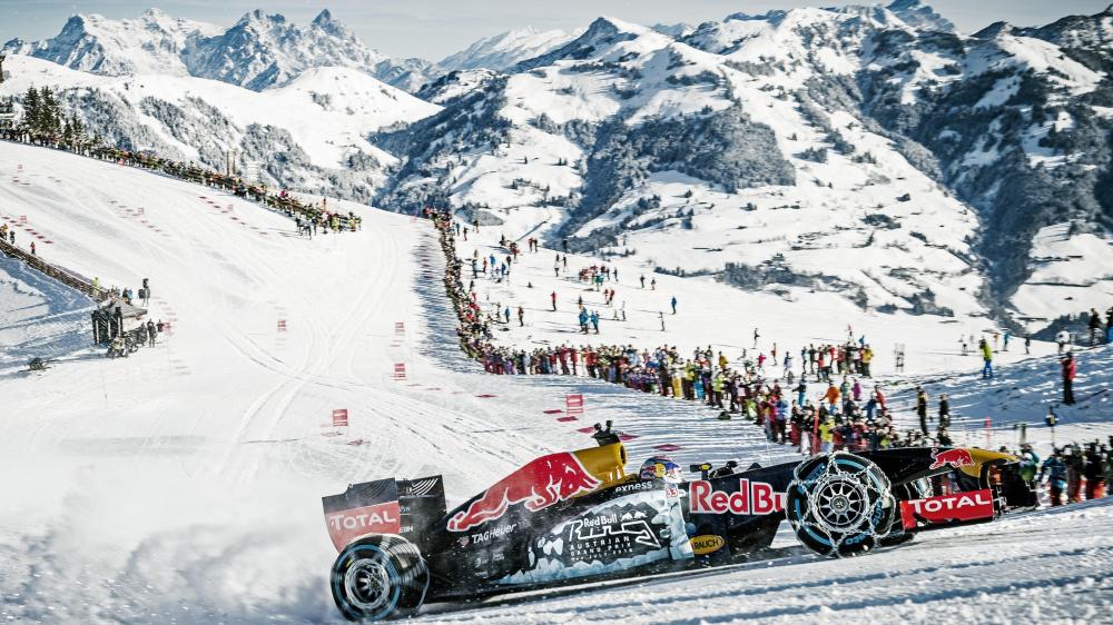 Racing on Ice: Red Bull Car Challenges Alpine Slopes wallpaper