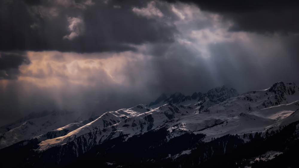 Dramatic Alpine Sky Over Snowy Peaks wallpaper