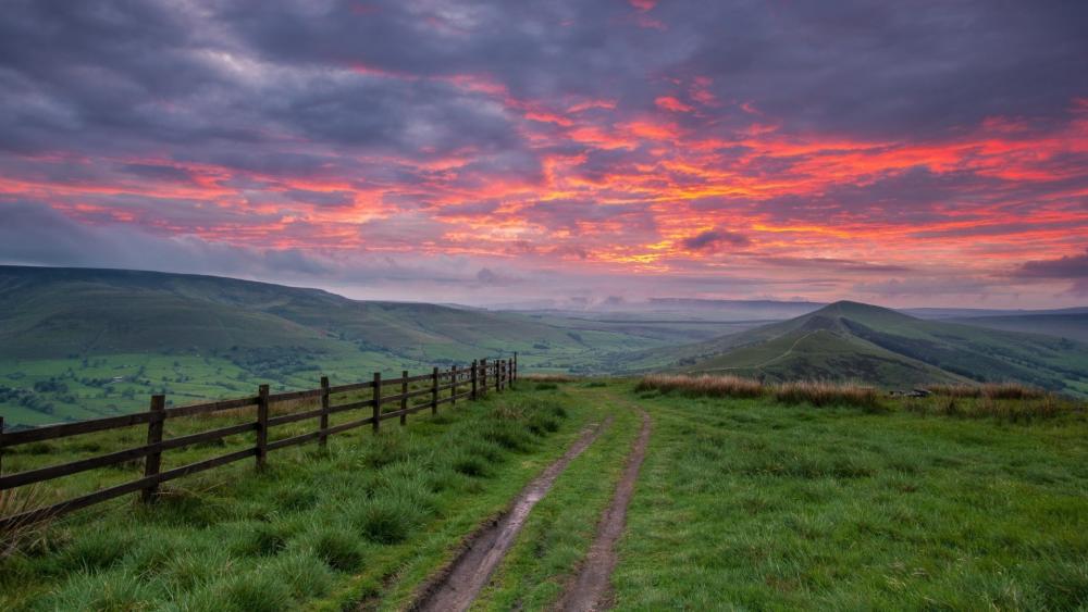 Majestic Sunset Over Rolling Hills and Valleys wallpaper