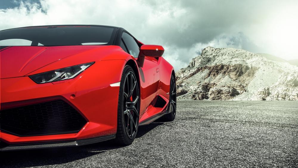 Vibrant Red Supercar Against Dramatic Landscape wallpaper