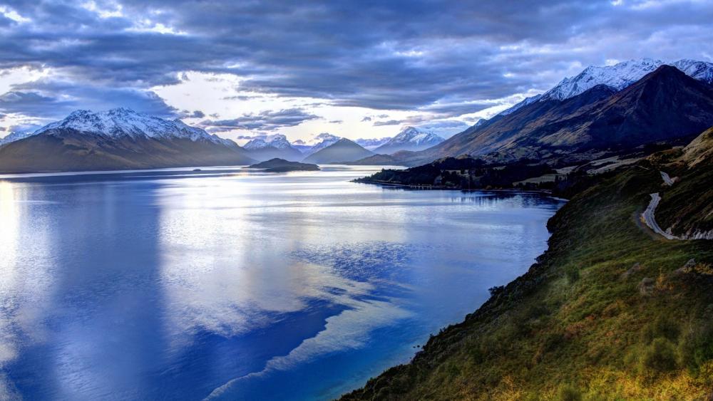 Serene Mountain Reflection on Tranquil Waters wallpaper