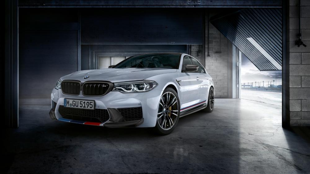 Sleek BMW M5 in a Stylish Garage Setting wallpaper