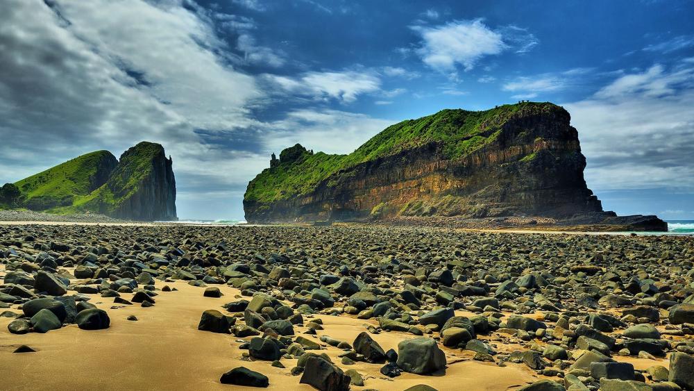 Mysterious Coastal Landscape with Rugged Bluffs and Pebbled Shoreline wallpaper