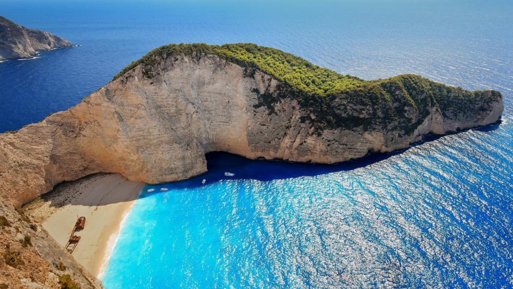 Stunning Coastal Landscape with Crystal Clear Waters and Rocky Cliffs wallpaper
