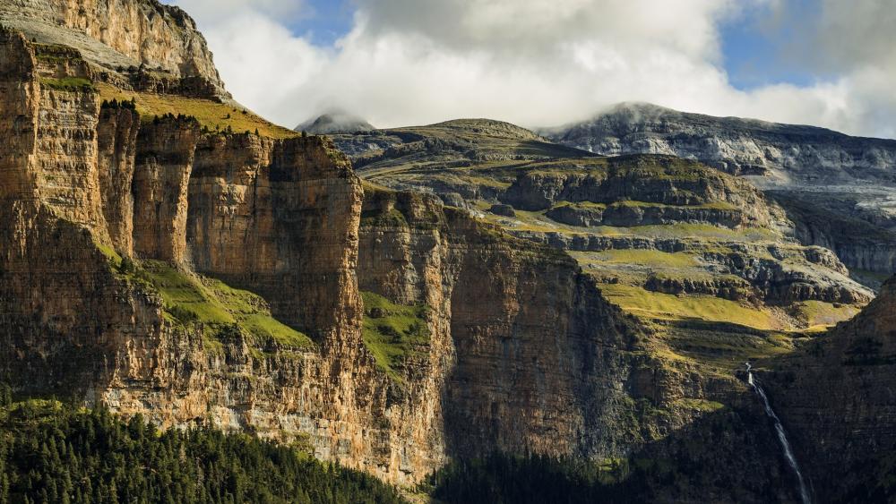 Majestic Mountain Landscape with Lush Greenery and Waterfall wallpaper