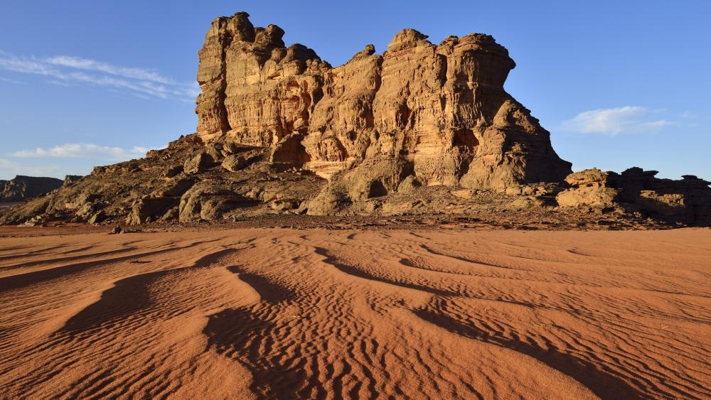 Majestic Desert Landscape with Towering Rock Formation wallpaper