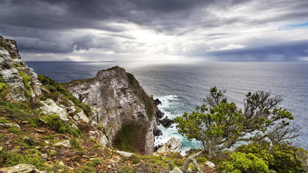 Majestic Coastal View Under Dramatic Skies wallpaper
