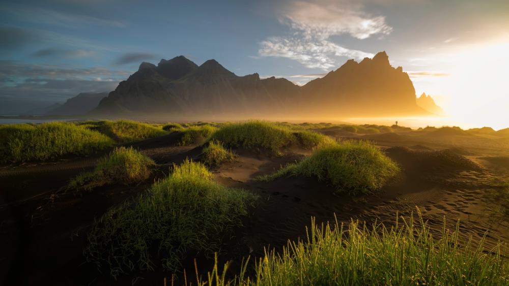 Breathtaking Sunrise Over Serene Coastal Mountains wallpaper