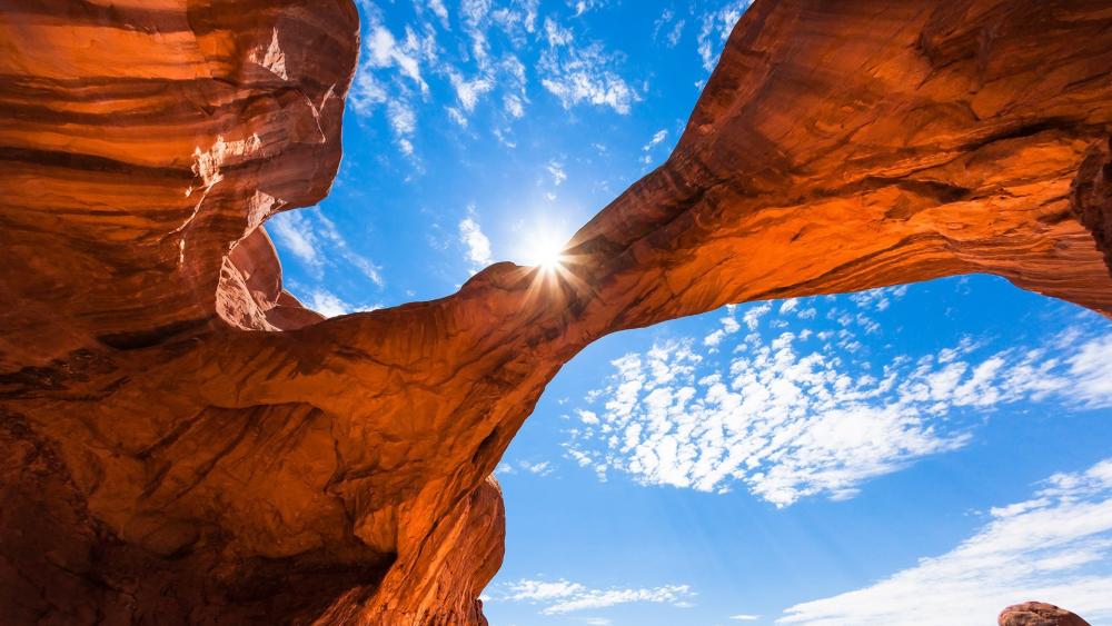 Majestic Arch Beneath Vast Blue Sky wallpaper