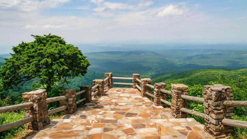 Serene Mountain View Overlooking Lush Valleys and Blue Skies wallpaper