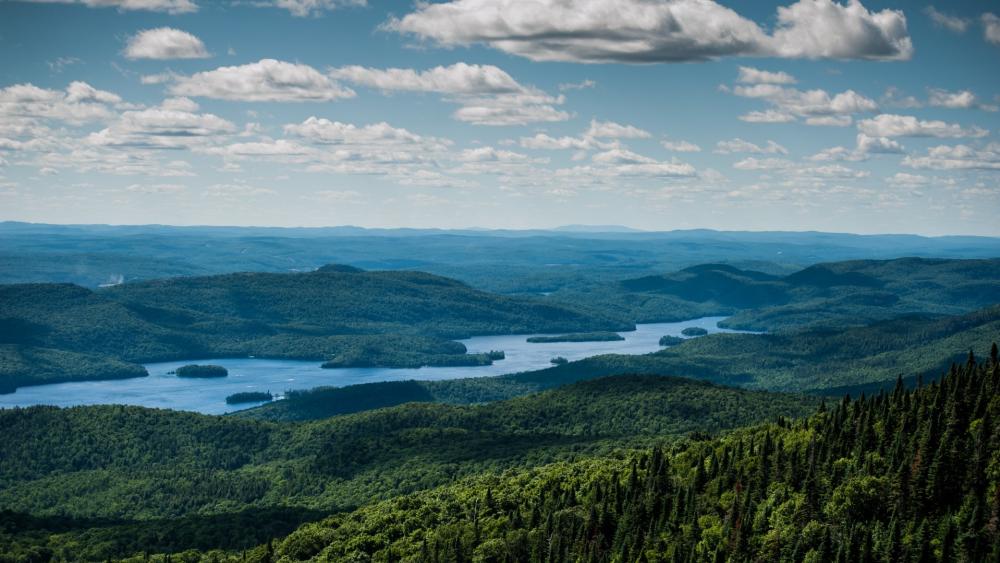 Breathtaking Vista of Lush Green Mountains and Serene Lakes wallpaper