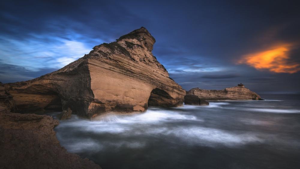 Majestic Coastal Cliffs Under a Dramatic Sky wallpaper