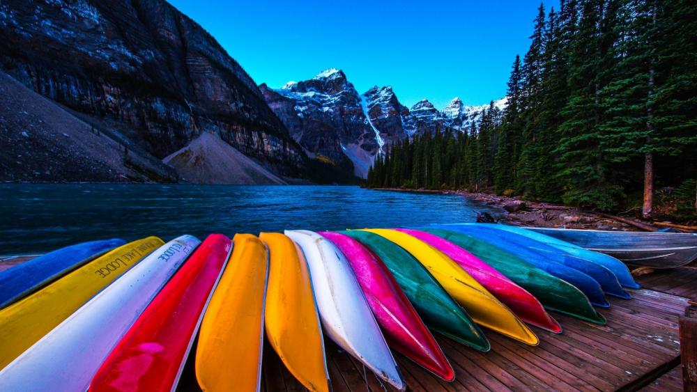Vibrant Canoes by Serene Mountain Lake wallpaper