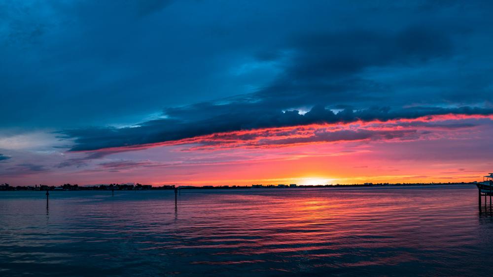 Vibrant Sunset Over Tranquil Waters wallpaper