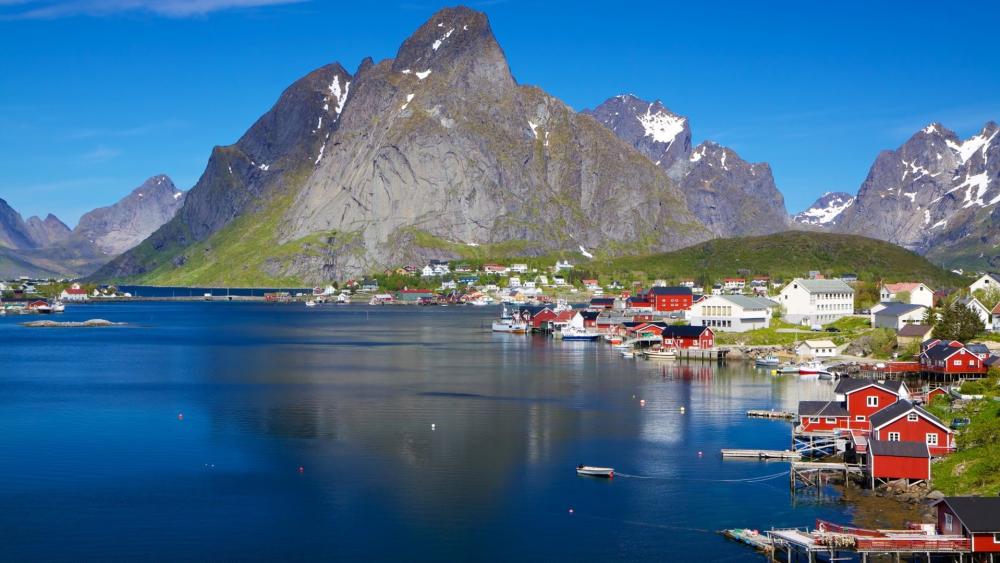 Breathtaking Fjord Landscape with Majestic Mountains and Vibrant Houses wallpaper
