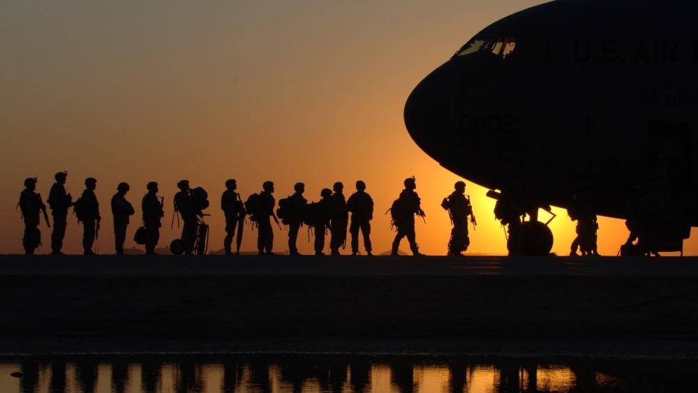 Silhouetted Soldiers Boarding at Sunrise wallpaper