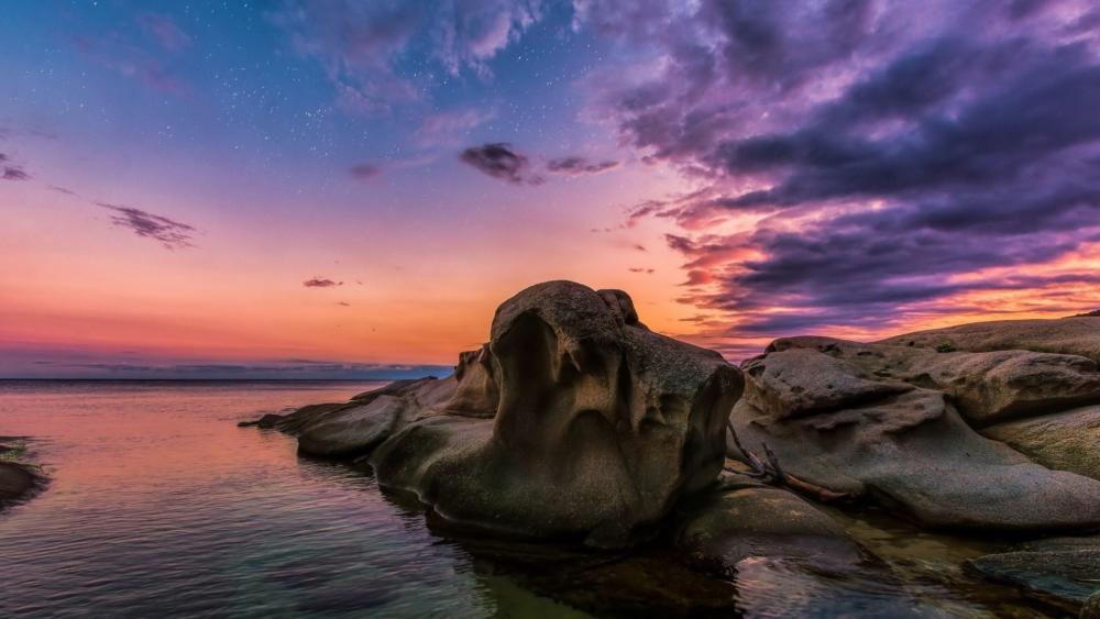 Serene Coastal Sunset with Unique Rock Formations wallpaper