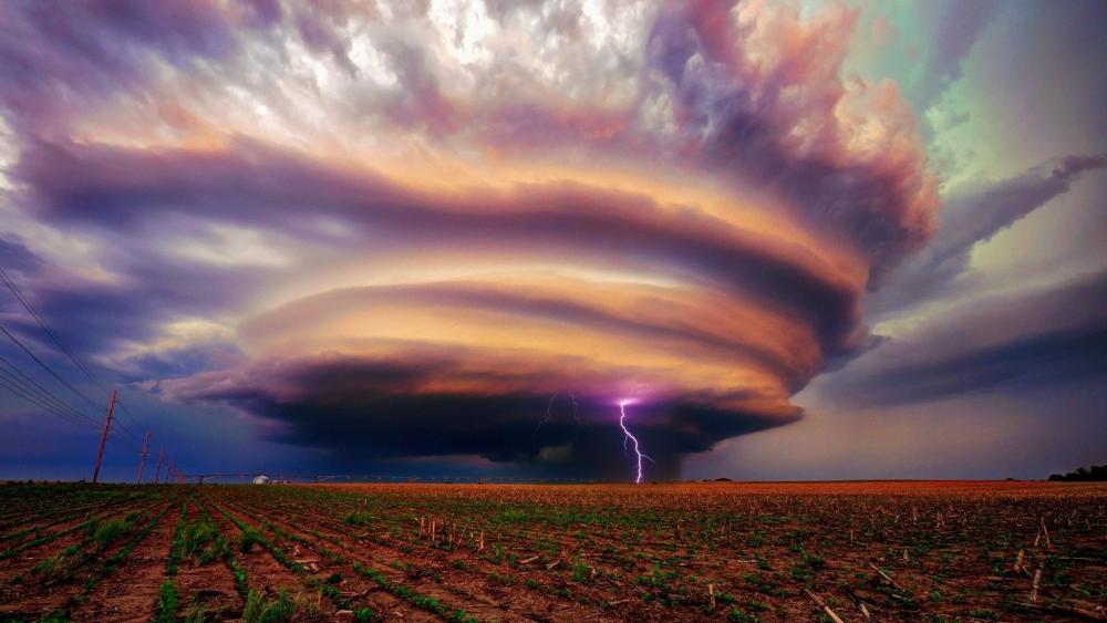 Majestic Storm Unleashes on Tranquil Plains wallpaper