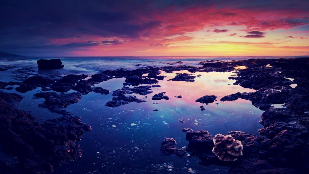 Stunning Sunset Over Rocky Shoreline wallpaper