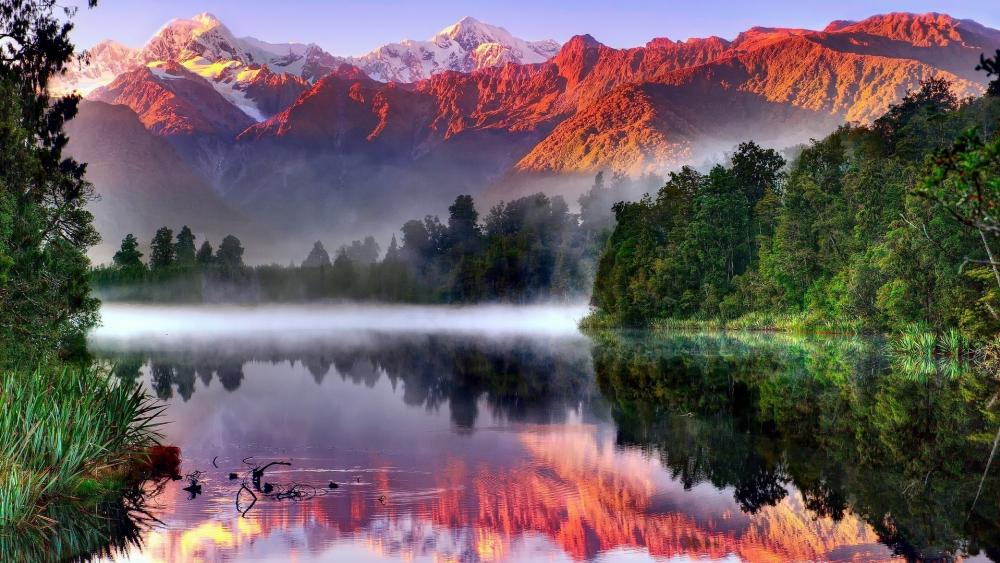 Pink mountains reflected in the Lake Matheson, Westland Tai Poutini National Park wallpaper