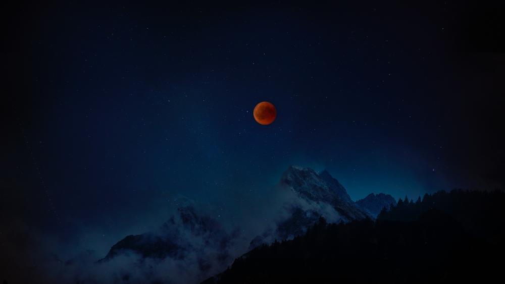 Mystical Red Moon Over Mountain Peaks wallpaper