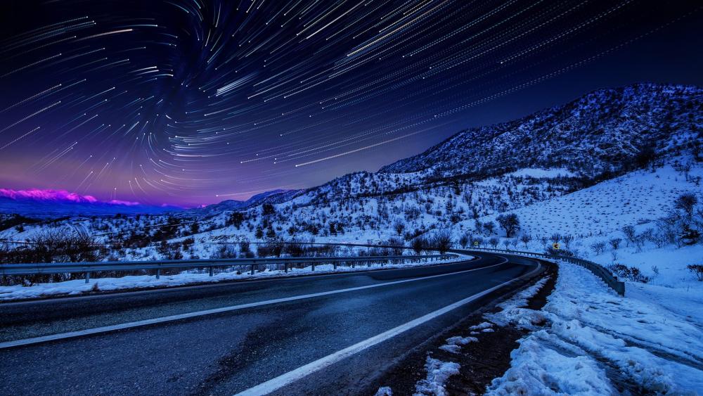 Winter Whirl - Star Trails Over Snowy Mountain Pass wallpaper