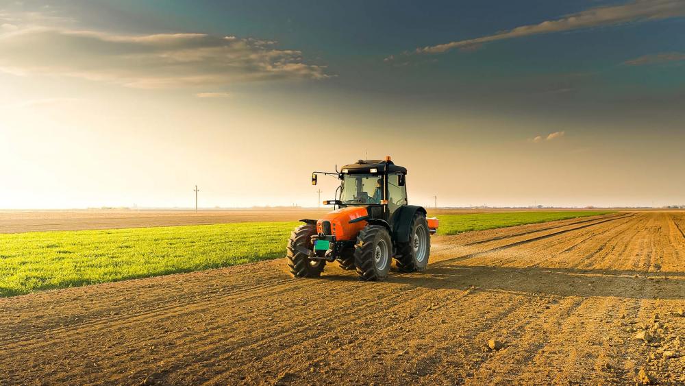 Sunset Tractor in Farmland wallpaper