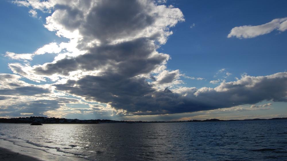 Dramatic Clouds Over a Serene Ocean Scene wallpaper