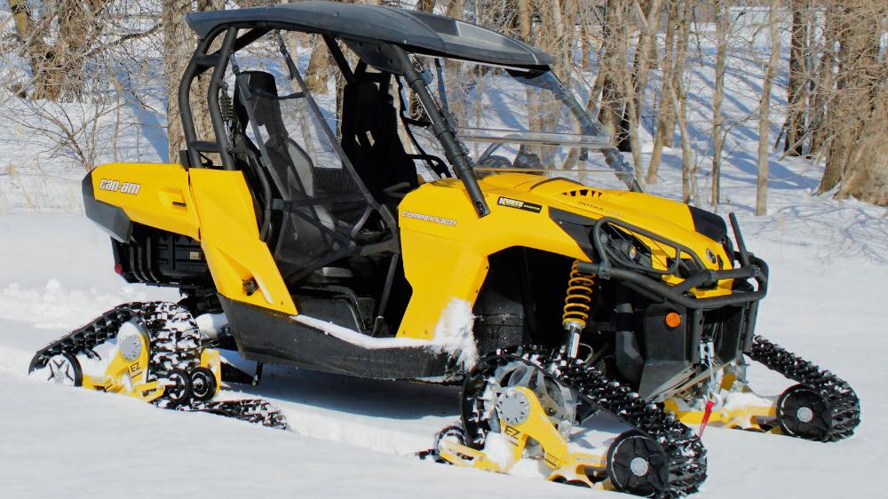 Yellow All-Terrain Vehicle in Snowy Landscape wallpaper