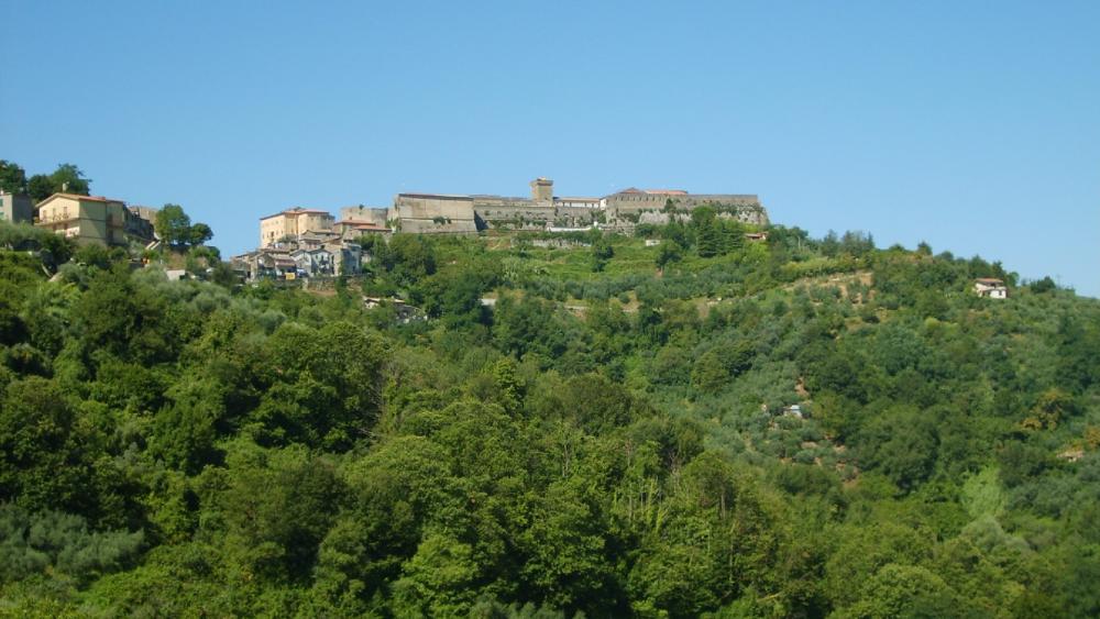 Serene Hillside Village Under Clear Blue Sky wallpaper