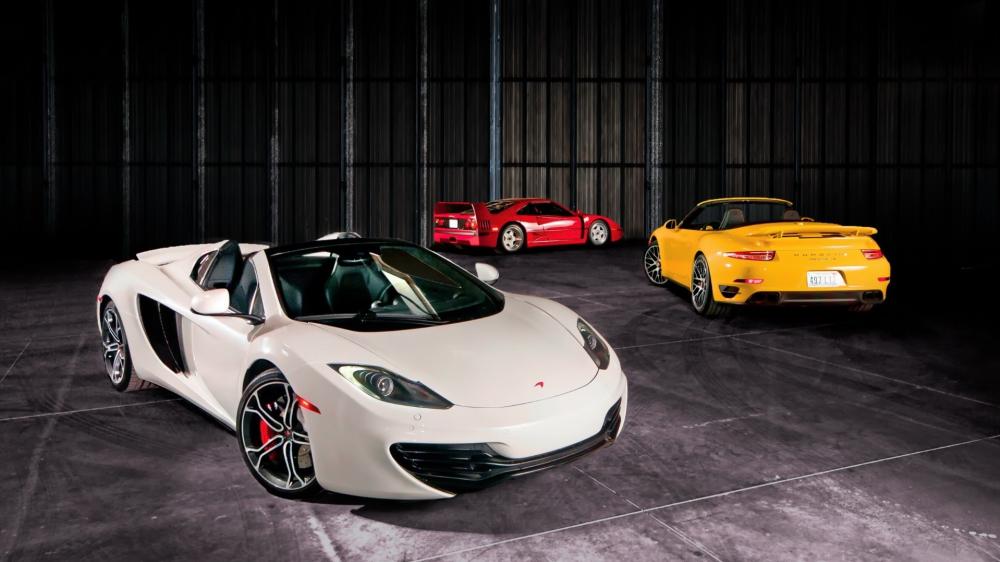 Sleek Supercars in Modern Warehouse Environment wallpaper