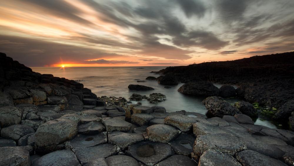 Sunset Over Serene Coastal Rocks at Dusk wallpaper