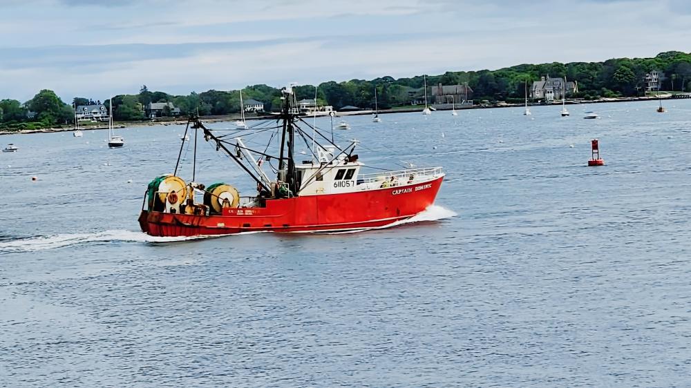 Fishing Vessel Navigates Serene Waters wallpaper