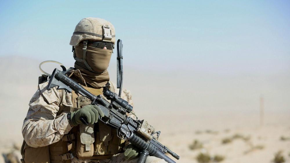 Soldier Ready for Combat in Desert Terrain wallpaper