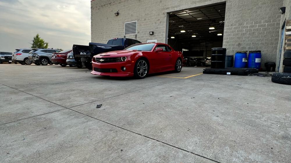 Vibrant Red Camaro in a Garage Setting wallpaper