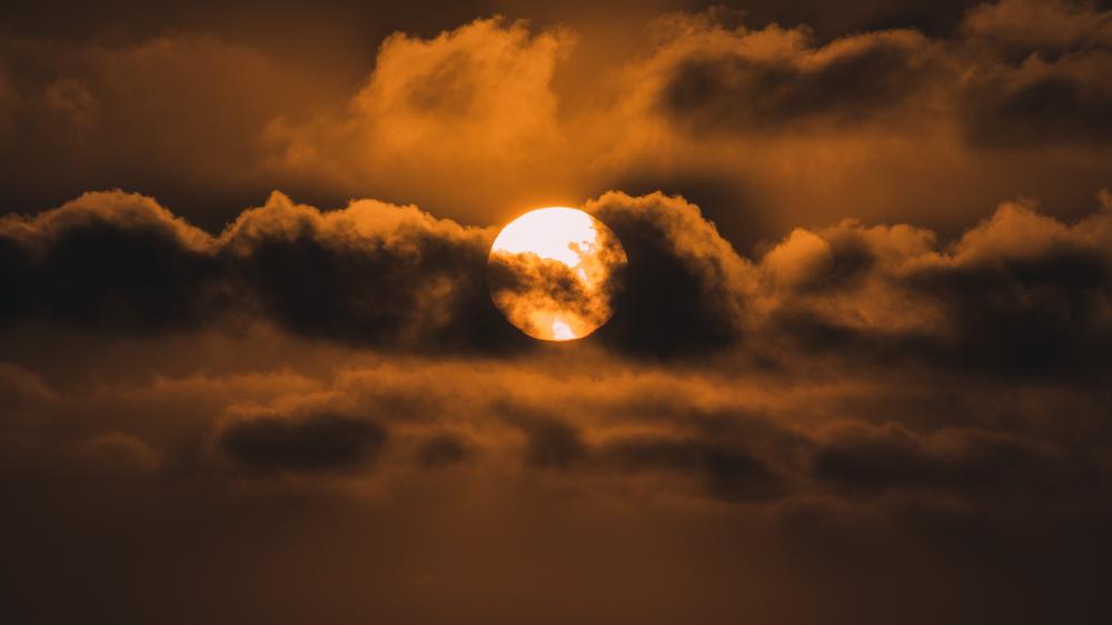Sun shrouded by clouds wallpaper
