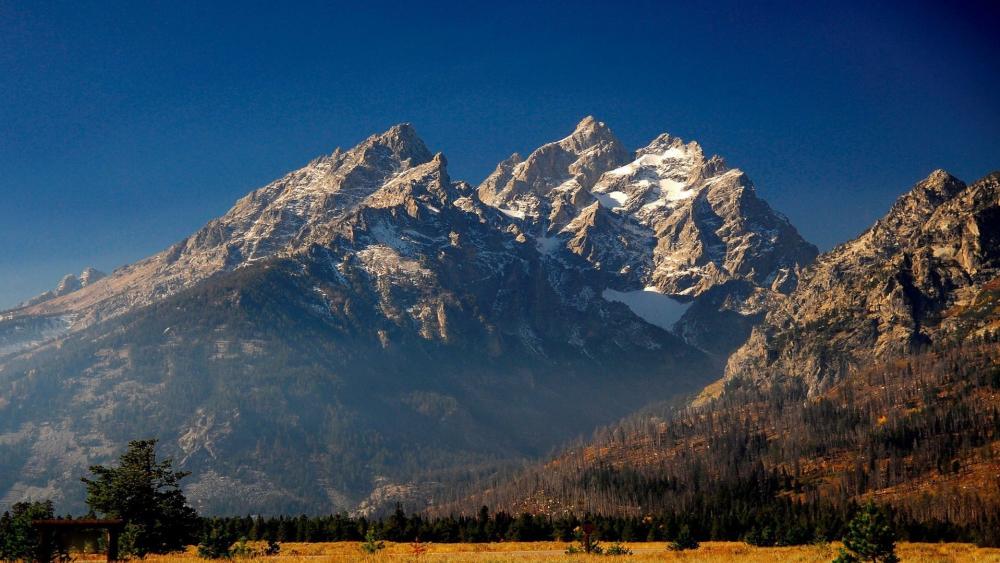 Majestic Mountain Peaks Against a Clear Blue Sky wallpaper