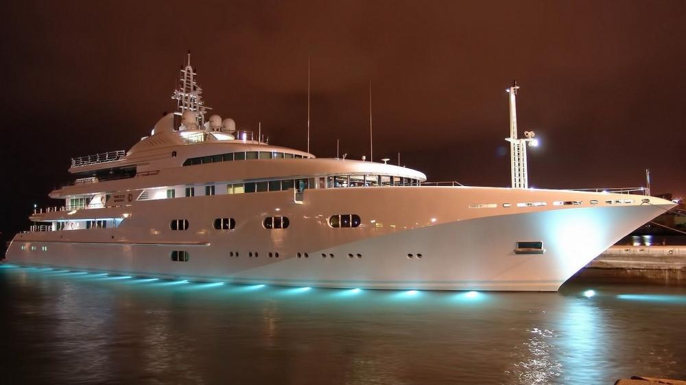 Luxurious Yacht Illuminated Against Night Sky wallpaper